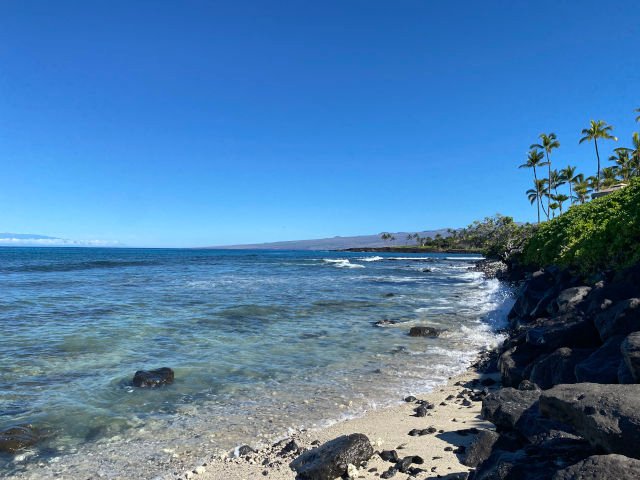 View of the sandy rocky beach at the beach access of the Hilton Waikoloa.