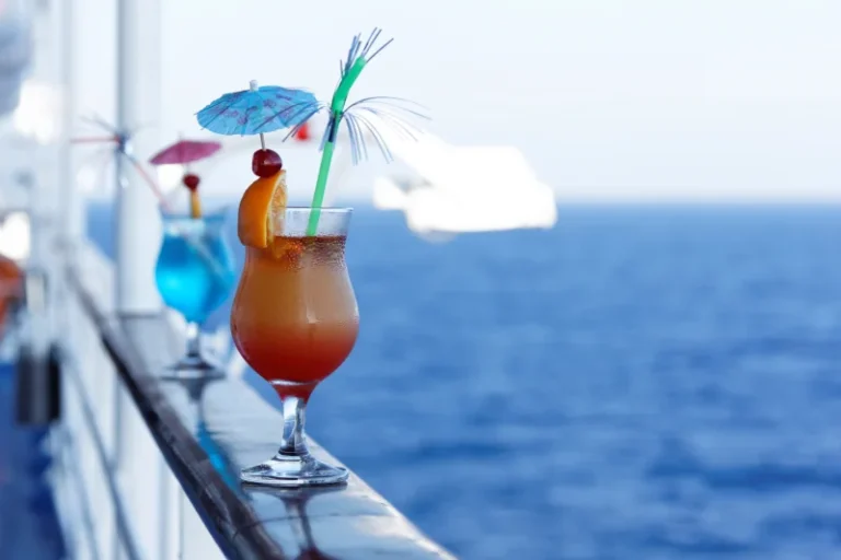 View of two drinks on the handrail of a cruise ship
