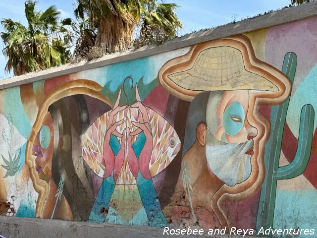 Picture of an art mural in La Paz. This art mural is of two people and a fish is found on Calle Antonio Mijares.