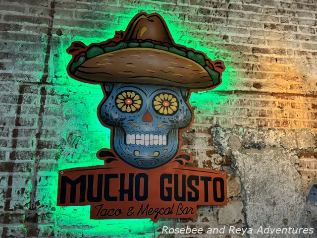 Picture of the Mucho Gusto Tacos and Mezcal Bar sign inside of the restaurant.
