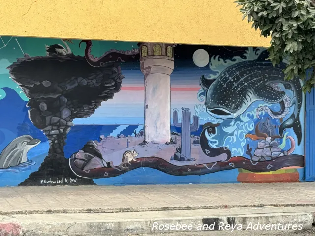 Picture of an art mural found in La Paz with a whale shark and Mushroom Rock from Playa Balandra.