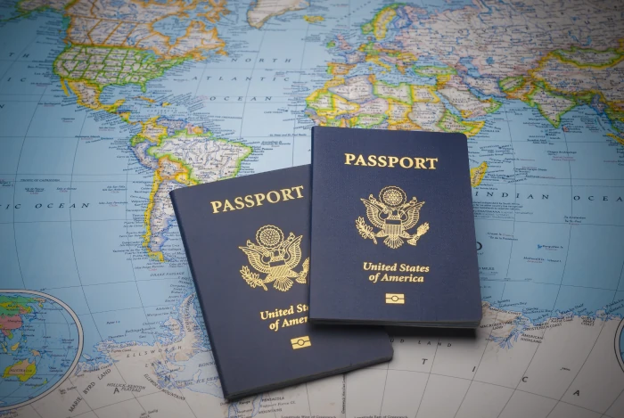 View of two United States Passports lying on a map of the world.