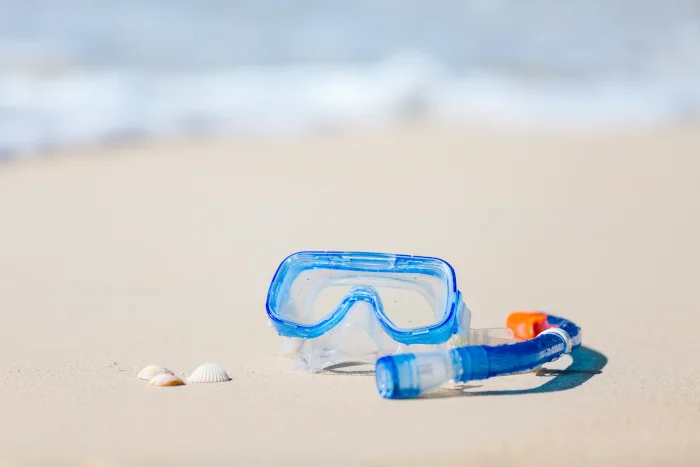 View of snorkeling gear on a soft sand beach