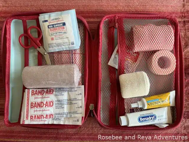 First aid kit with first aid essentials such as bandages, Neosporin, and Benadryl.