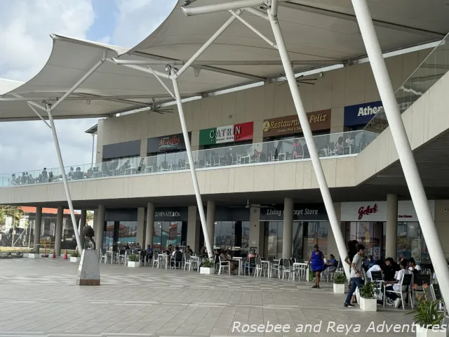 Picture of restaurant options and stores at the Colon duty-free mall and the outdoor seating where you can eat by the Colon cruise port.