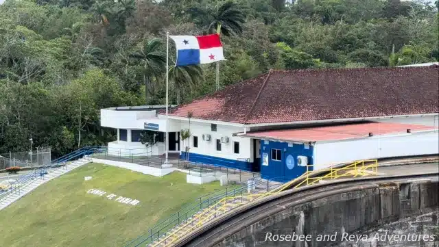 Picture of the Panama flag at the building for the Gatun Locks on the Panama Canal and the words Canal de Panama spelled out on the grass in front of the building