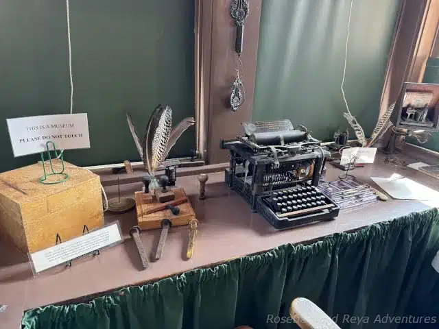 Picture in the station agent office of the Santa Anita Depot with an railroad stakes, an old typewriter, and a telegraph