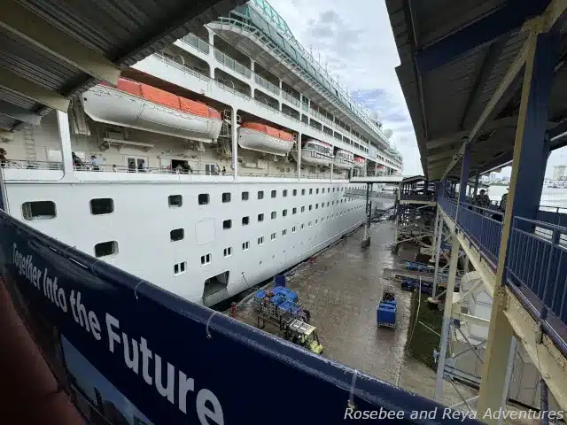 Picture of Rhapsody of the Seas docked at the San Juan Cruise Terminal, Pan American Pier, as people make their way to board the ship