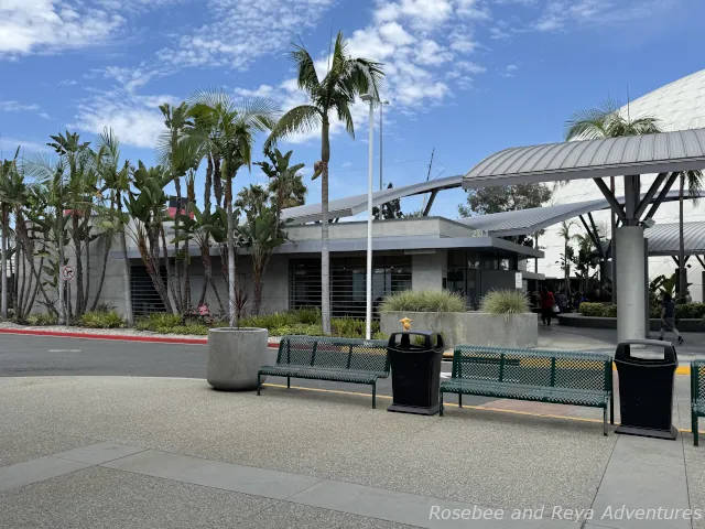 Picture looking towards the Long Beach cruise terminal and the building with a restroom and area to pick up mobility device rentals from the parking garage.