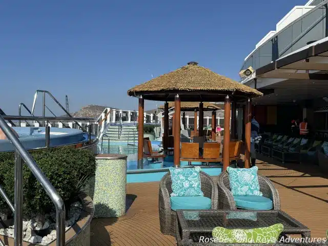 Picture of Carnival Cruise Line's Havana Experience on the Carnival Panorama with the two hot tubs, pool, and seating area on the pool sun shelf.